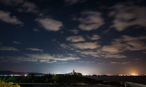 Buildings in city against sky at night