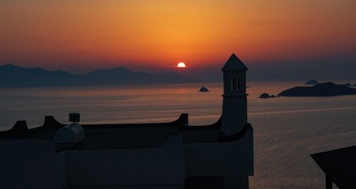 Scenic view of sea against orange sky