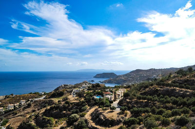 Scenic view of sea and mountains against blue sky