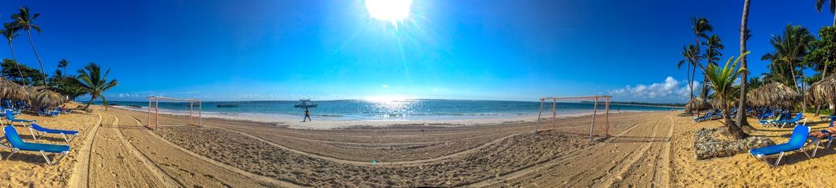 Panoramic view of beach against sky on sunny day