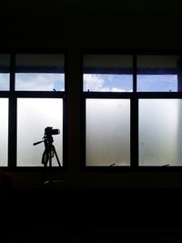 Man photographing through window
