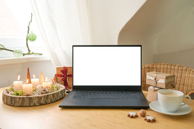 Coffee and laptop on table