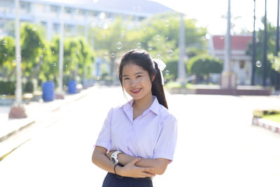 Portrait of a smiling young woman standing outdoors
