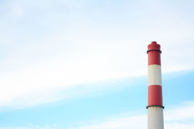 Low angle view of smoke stack against sky