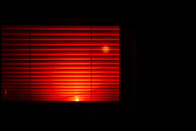 Illuminated window blinds at night