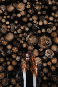 Full length portrait of woman standing on wood