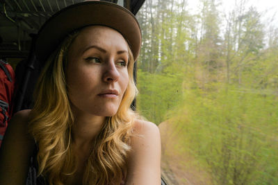 Close-up of young woman sitting in train