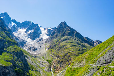 Scenic view of mountains against clear blue sky