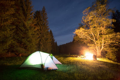 Tent on field against sky at night