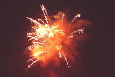 Low angle view of firework display at night