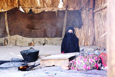 Woman sitting in hut