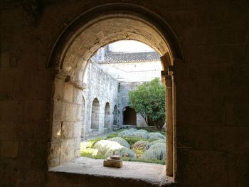 View of historic building seen through arch window