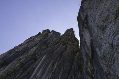 Low angle view of rock formation against clear sky