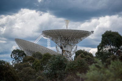 Low angle view of communications tower against sky