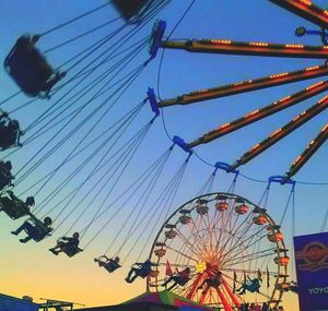 Low angle view of ferris wheel against sky