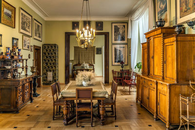 Chairs and tables in illuminated room at home