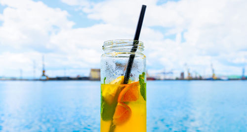 Close-up of drink on glass against water