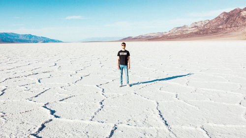 Full length of man standing on arid landscape