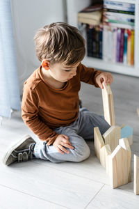 Boy sitting on floor at home