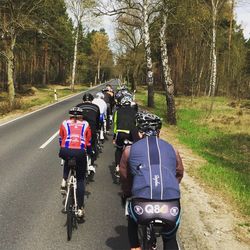 People riding bicycle on road