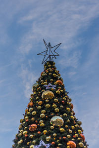 Low angle view of christmas tree against sky