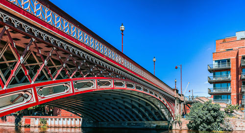 Low angle view of bridge against clear blue sky in leeds, uk