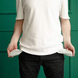 Midsection of man with empty pockets