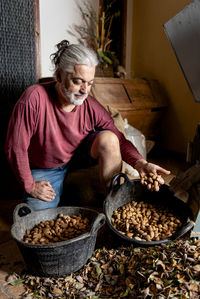 Male farmer proudly checking his almond harvest.