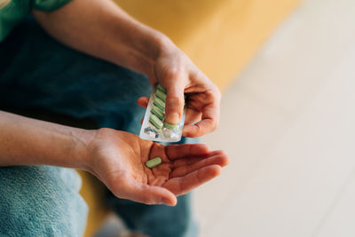 Close-up of a pack of antidepressant or painkillers pills in female hands.