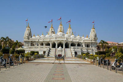Group of people in temple against clear sky