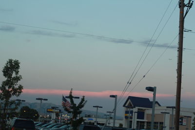 Street amidst buildings against sky at dusk