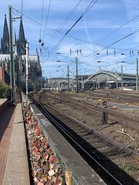 Railroad tracks by train against sky