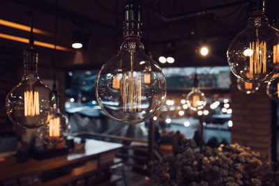 Close-up of illuminated light bulb at night