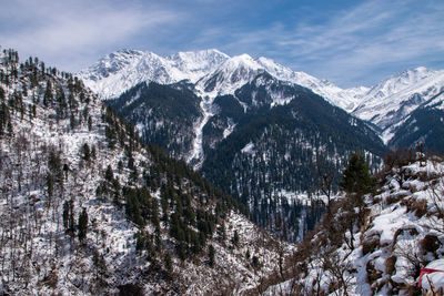 Scenic view of snowcapped mountains against sky