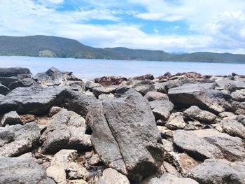 Rocks on beach against sky