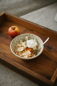 High angle view of breakfast on the couch at home, healthy eating, porridge, apple and tea.