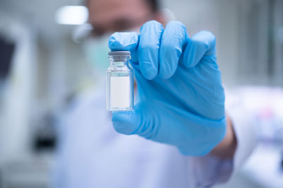 Close-up of person holding bottle