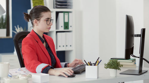 Businesswoman using laptop at office