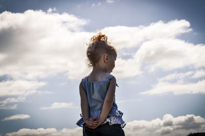 Girl standing against sky