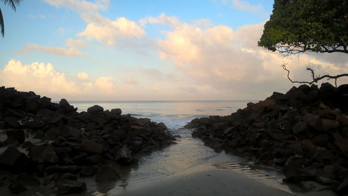 View of rocky beach against sky