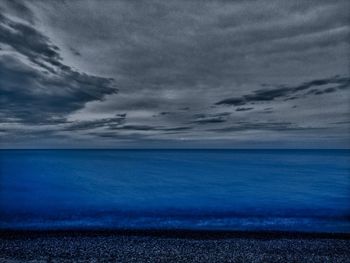 Scenic view of sea against storm clouds