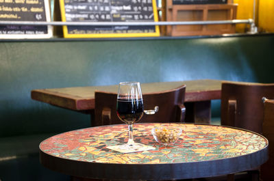 Red wine glass on table at bar