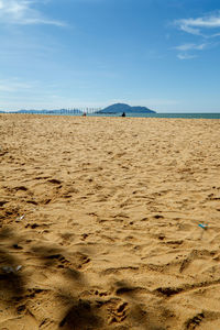 Scenic view of beach against blue sky