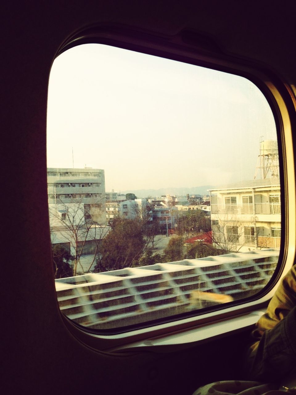 window, transportation, car, mode of transport, architecture, land vehicle, clear sky, built structure, indoors, vehicle interior, glass - material, transparent, building exterior, copy space, city, road, day, travel, street, sky