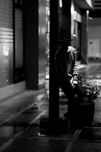 Side view of man sitting on road