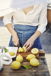 Woman cutting lemons