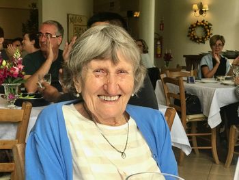 Portrait of smiling woman sitting on table