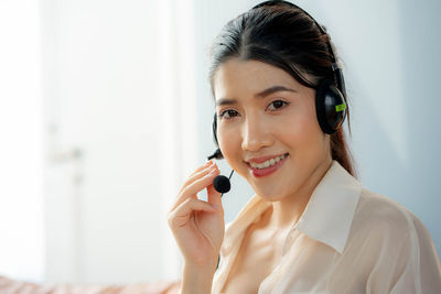 Thoughtful young woman talking on phone