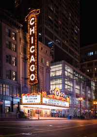 Illuminated city street and buildings at night