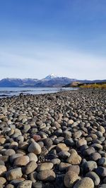 Surface level of stones on land against sky with volcano lanin